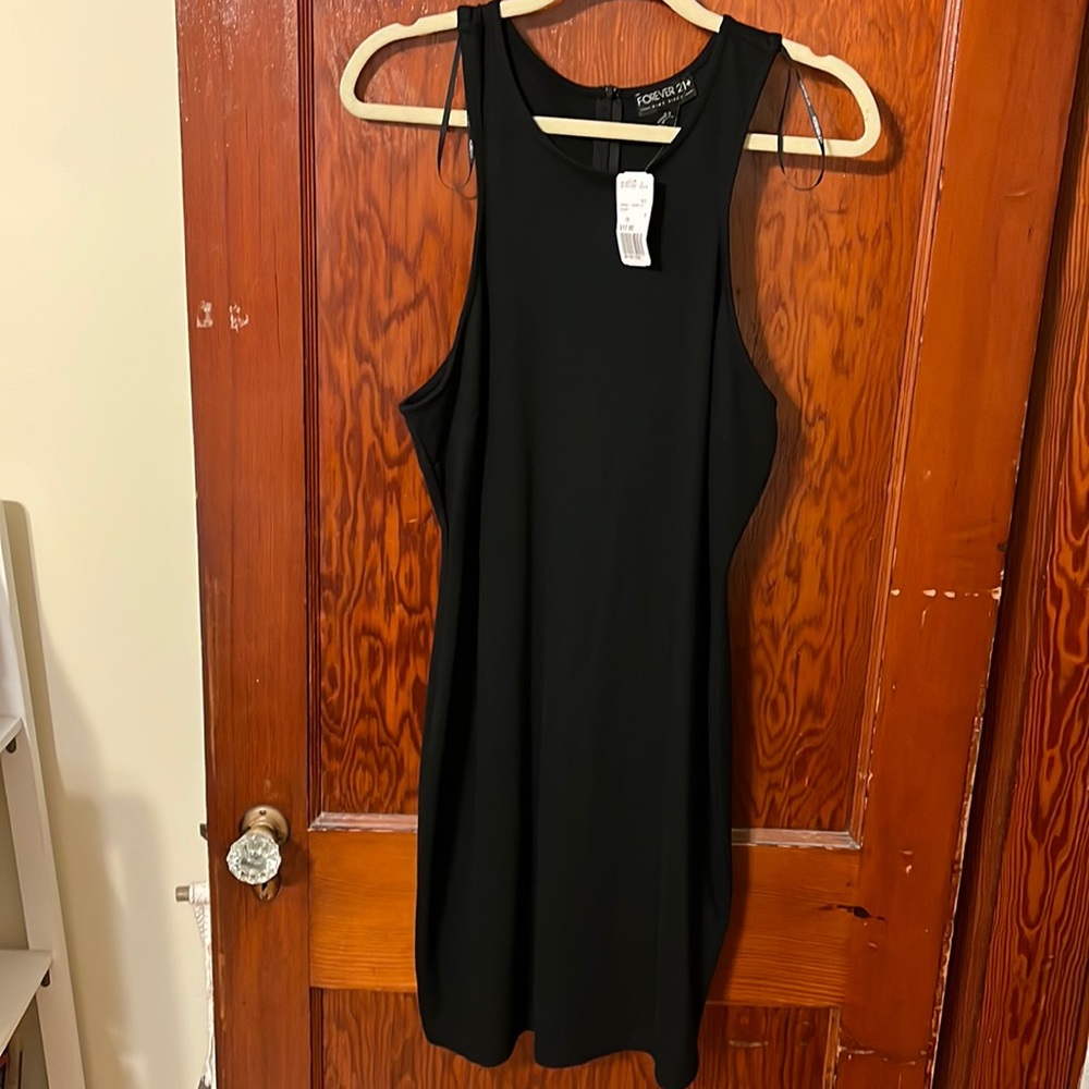 Forever 21 sleeveless knee length black dress. Size 1X. New with tags.